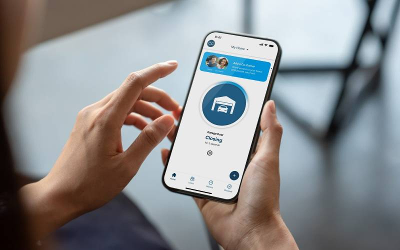 Smartphone displaying MyQ app controlling garage door.