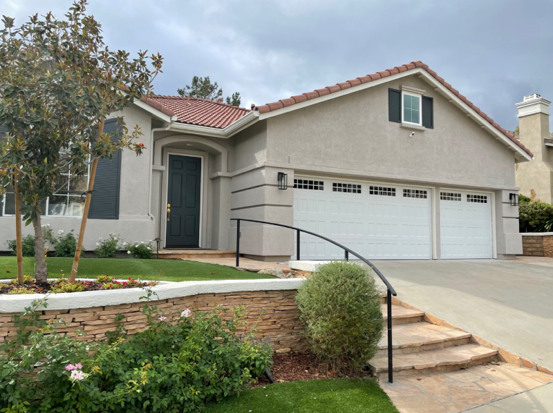 Amarr Hillcrest recessed garage door in white with Stockton clear glass windows, Simi Valley home exterior.