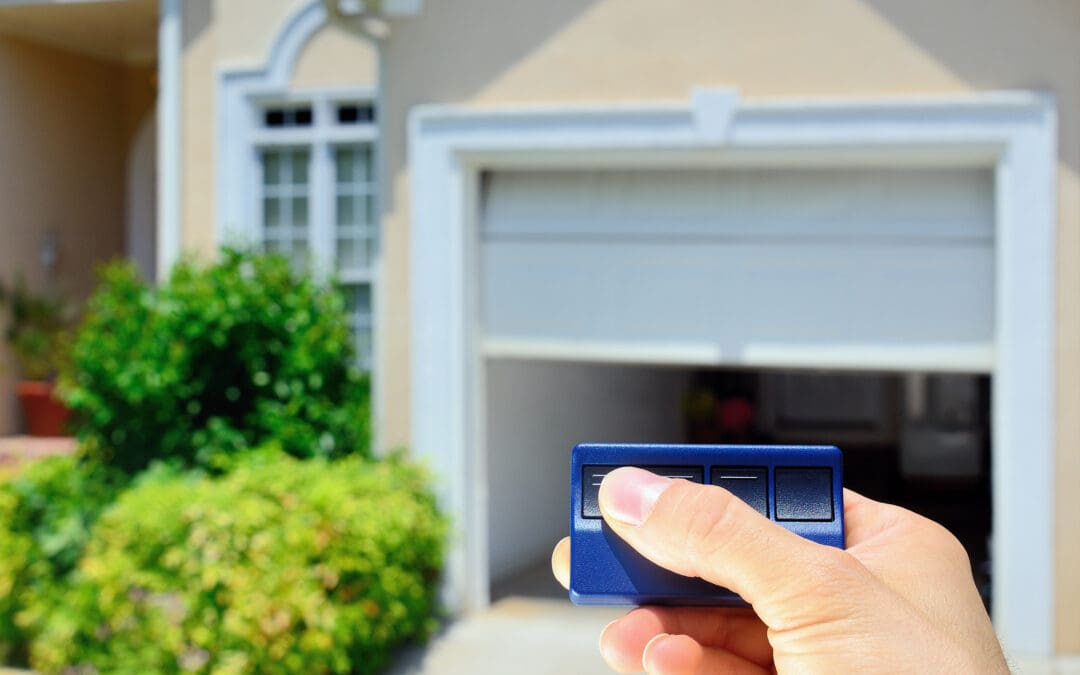 Garage door opener remote control in hand, professional installation in Simi Valley