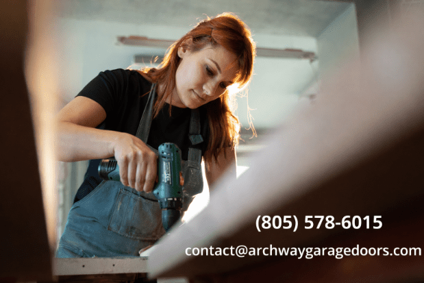 Archway Garage Doors technician repairing garage door components, addressing coastal salt damage.