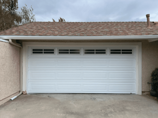 White garage door with windows and panels, illustrating preventative maintenance in Studio City.