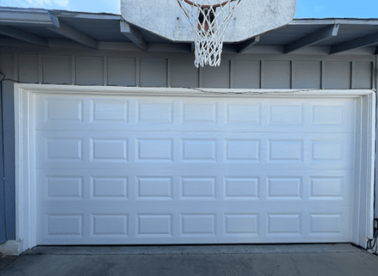 Broken garage door spring and safety risk in Encino.